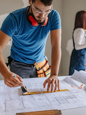 man working on an architectural layout