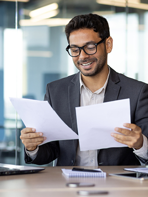 A man looking at documents in an office