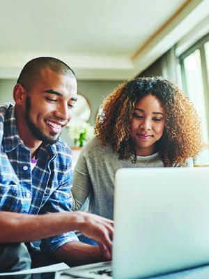 man and woman looking at computer