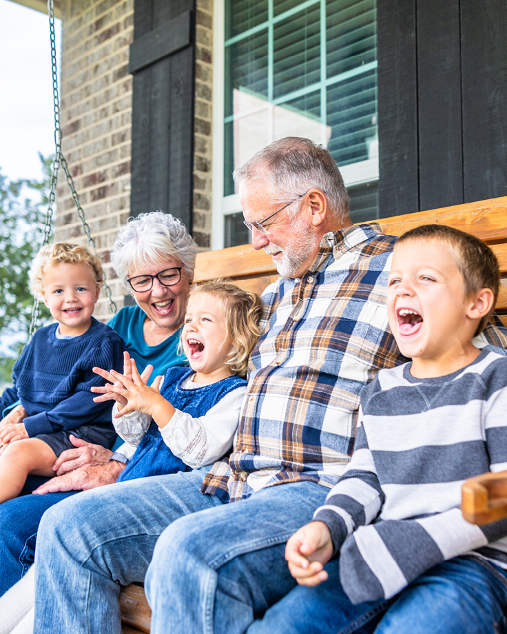 Grandparents laughing with grandkids