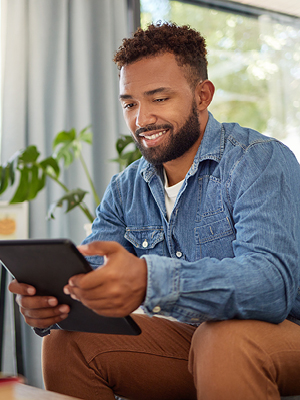 man looking at a computer tablet