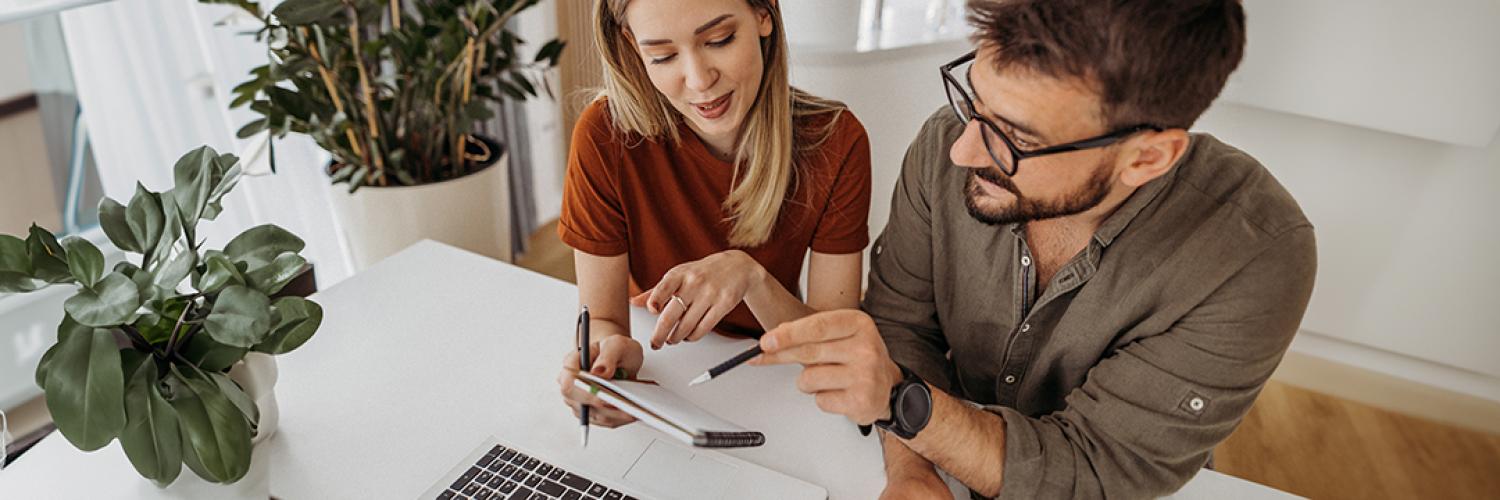 man and woman looking at a notepad