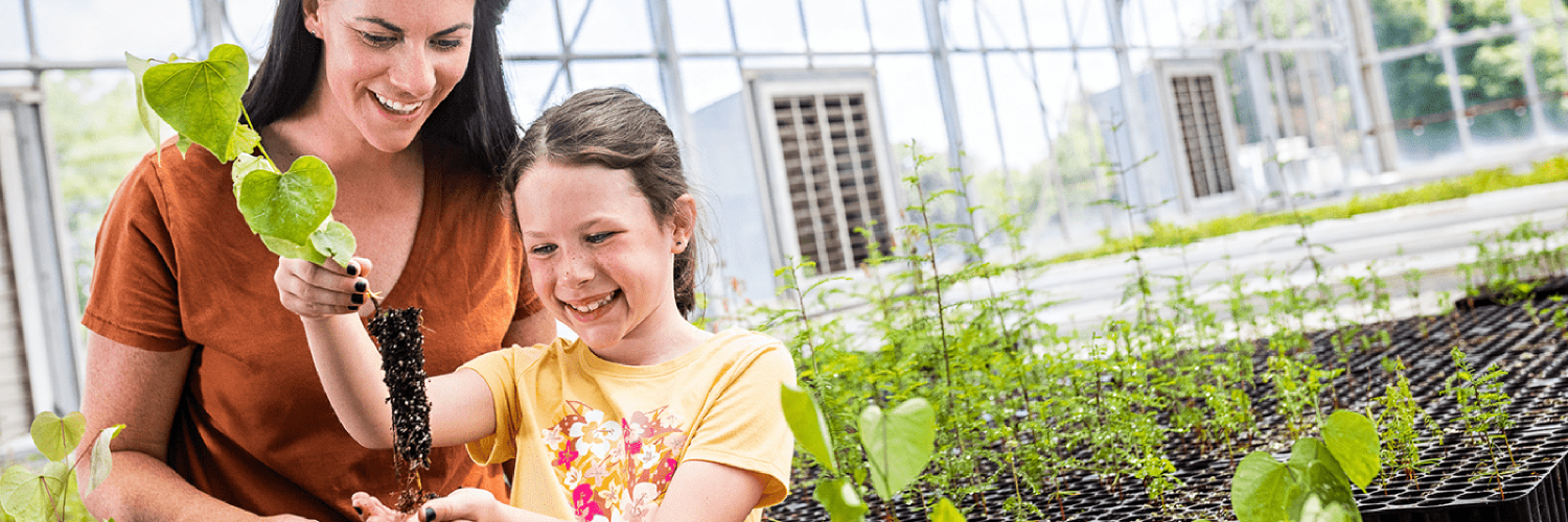 mom and daughter in a greenhouse