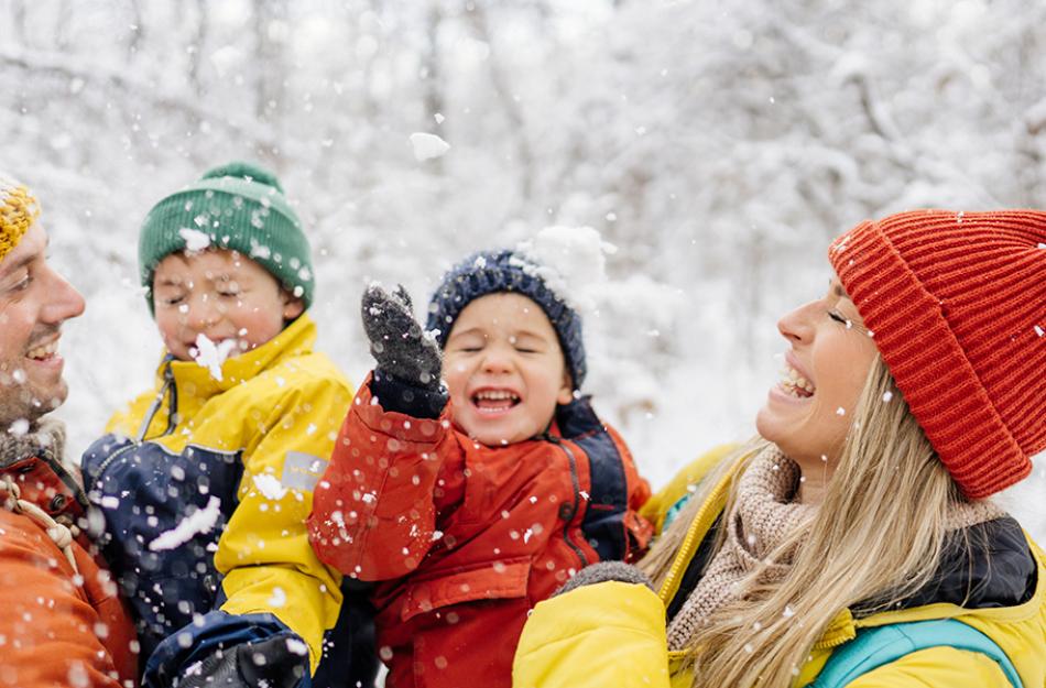 family playing in the snow