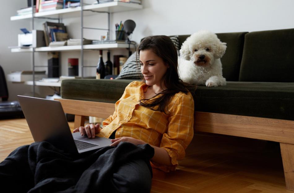 woman on a laptop with a dog