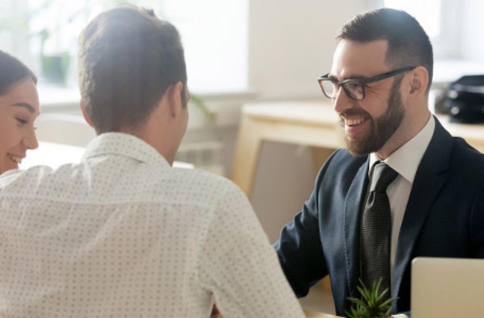 man working with a couple at a desk