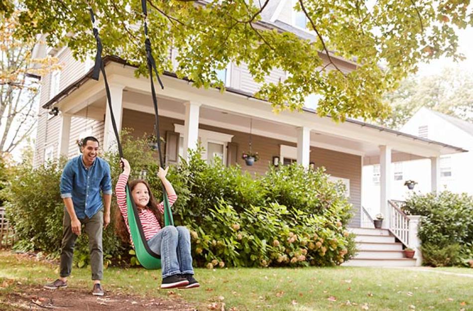 man pushing a girl in a swing