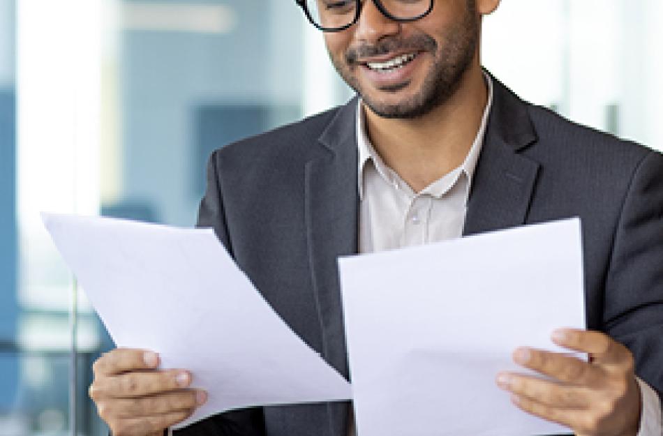 A man looking at documents in an office 