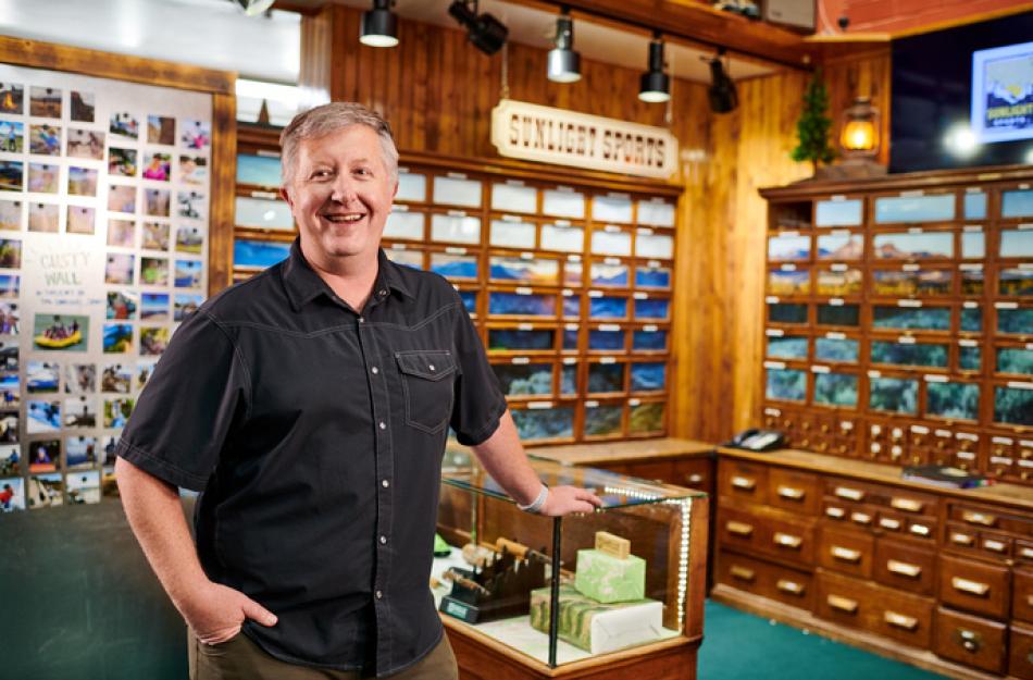 Businessman smiling behind the counter