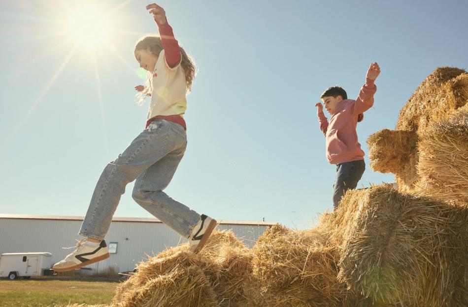 kids jumping on hay bales
