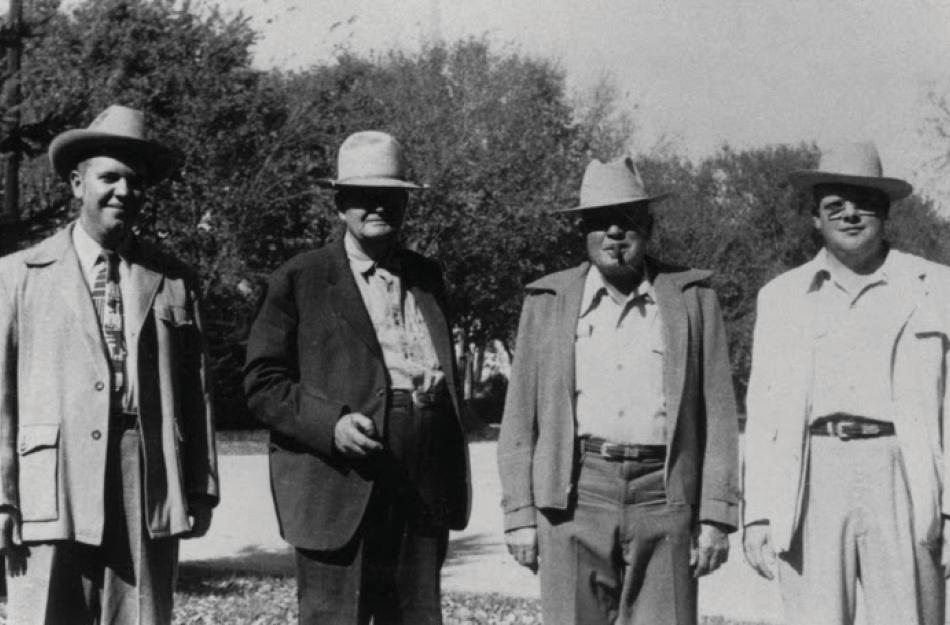 picture of 4 men in a black and white picture