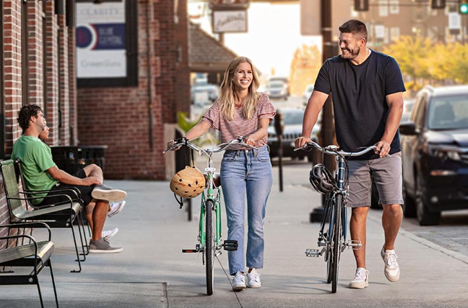 picture of two people walking their bikes