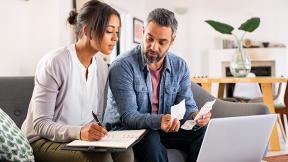 Two people sitting and creating a budget together. 