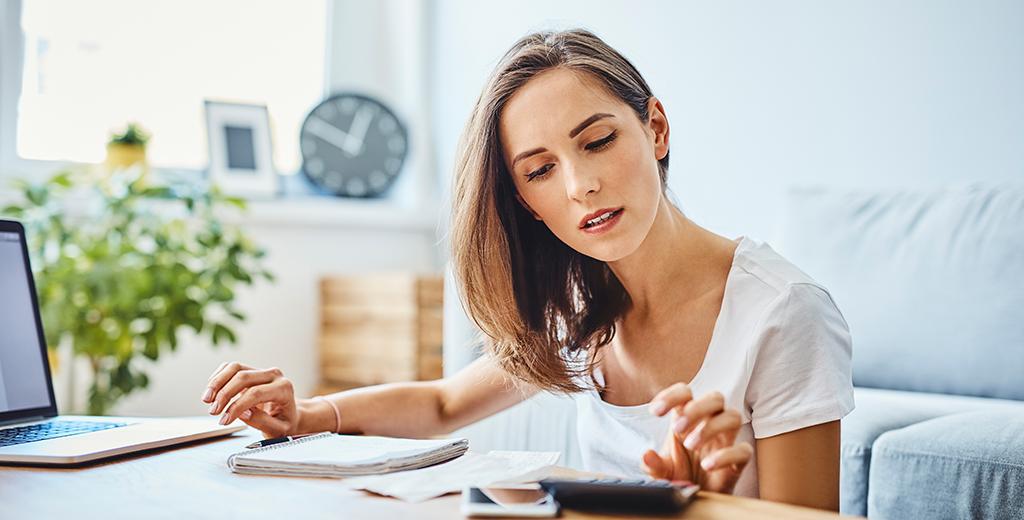 A girl doing calculations for her budget.