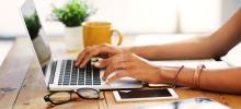 hands typing on a laptop