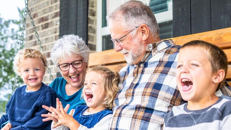 grandparents laughing with grandkids